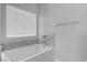 Bathroom featuring a soaking tub, tile surround, and ample natural light at 5264 Mystic Ivy Dr, Las Vegas, NV 89149