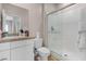 Bright bathroom featuring a shower with sliding glass door, granite countertops, and white cabinets at 5264 Mystic Ivy Dr, Las Vegas, NV 89149