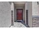 Close-up of the front door, featuring stone accents, modern hardware, and neutral color at 5264 Mystic Ivy Dr, Las Vegas, NV 89149