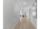 An inviting hallway with tile flooring, neutral paint, and glimpses of the living areas and natural light at 5264 Mystic Ivy Dr, Las Vegas, NV 89149