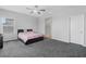 Main bedroom featuring carpet floors, a ceiling fan, and an ensuite bathroom at 5264 Mystic Ivy Dr, Las Vegas, NV 89149