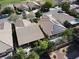 Aerial view of a neatly planned neighborhood with tile roofs, manicured yards, and a home with solar panels at 5439 E Cansano St, Pahrump, NV 89061