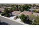 Aerial view of a neighborhood showcasing the tile roof and landscaped yards of the surrounding single-Gathering homes at 5439 E Cansano St, Pahrump, NV 89061