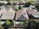 An aerial view of a house with solar panels, set among lush trees in a community of homes, all with tile roofs at 5439 E Cansano St, Pahrump, NV 89061