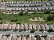 Expansive aerial view of a Primary-planned community near a golf course, featuring uniform homes and green spaces at 5439 E Cansano St, Pahrump, NV 89061