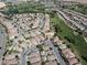 Sweeping aerial shot of a residential community alongside a golf course, dotted with trees and well-maintained homes at 5439 E Cansano St, Pahrump, NV 89061