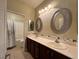 Bathroom with double sink vanity, decorative lighting and mirrors, and a shower and tub at 5439 E Cansano St, Pahrump, NV 89061