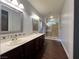 Bright bathroom featuring a double sink vanity, decorative mirrors and separate glass enclosed shower at 5439 E Cansano St, Pahrump, NV 89061
