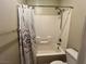 Bathroom with a white shower-tub combination with tiled walls and a decorative shower curtain at 5439 E Cansano St, Pahrump, NV 89061