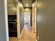 Hallway showing a laundry area with appliances, and doors leading to other rooms at 5439 E Cansano St, Pahrump, NV 89061