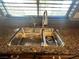 Close up of the stainless steel double sink, fixtures and granite countertop at 5439 E Cansano St, Pahrump, NV 89061
