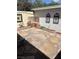 Private backyard with stone pavers, brick accents, and decorative wall art for outdoor enjoyment at 565 Greenbriar Townhouse Way, Las Vegas, NV 89121