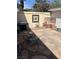 Private backyard featuring a stone patio, outdoor grill, and comfortable seating area for relaxation at 565 Greenbriar Townhouse Way, Las Vegas, NV 89121
