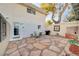 Charming backyard with flagstone patio, a brick fireplace, and outdoor seating at 565 Greenbriar Townhouse Way, Las Vegas, NV 89121