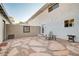 Backyard with flagstone patio, desert landscaping, and shaded seating area at 565 Greenbriar Townhouse Way, Las Vegas, NV 89121
