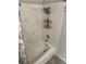 Close up of a bath tub with shower-head and white tiled surround in the bathroom at 565 Greenbriar Townhouse Way, Las Vegas, NV 89121
