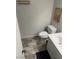 Bathroom with neutral colored walls, tile flooring, toilet and sink at 565 Greenbriar Townhouse Way, Las Vegas, NV 89121