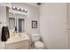 Cozy bathroom featuring a single sink vanity, standard toilet, and neutral wall decor at 565 Greenbriar Townhouse Way, Las Vegas, NV 89121