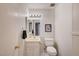 Compact bathroom features a sink with storage and a toilet at 565 Greenbriar Townhouse Way, Las Vegas, NV 89121