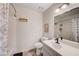 Cozy bathroom featuring a shower/tub with curtain and single sink vanity at 565 Greenbriar Townhouse Way, Las Vegas, NV 89121