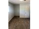 Small bedroom has vinyl flooring and a window at 565 Greenbriar Townhouse Way, Las Vegas, NV 89121