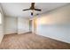 This bedroom offers wood-look floors, a ceiling fan, and a large closet at 565 Greenbriar Townhouse Way, Las Vegas, NV 89121