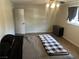 Bedroom with laminate flooring, a window, and a gray dresser with drawers at 565 Greenbriar Townhouse Way, Las Vegas, NV 89121