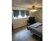 Bedroom with built in wardrobe and laminate floors, furnished with computer and bed at 565 Greenbriar Townhouse Way, Las Vegas, NV 89121