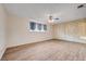 Spacious bedroom with vinyl flooring, ceiling fan, and closet with paneled doors at 565 Greenbriar Townhouse Way, Las Vegas, NV 89121