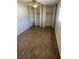 A simple bedroom with vinyl flooring and large closet space at 565 Greenbriar Townhouse Way, Las Vegas, NV 89121