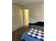 Bedroom with built in wardrobe and laminate floors, and bathroom access at 565 Greenbriar Townhouse Way, Las Vegas, NV 89121