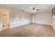 Bright bedroom with vinyl floors, ceiling fan, closet with paneled doors, and ensuite bathroom at 565 Greenbriar Townhouse Way, Las Vegas, NV 89121