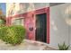 Front entry to the townhome featuring a secure gate and well-kept landscaping at 565 Greenbriar Townhouse Way, Las Vegas, NV 89121