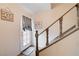 Inviting entryway with wood-look flooring, door with decorative curtain, and gray staircase at 565 Greenbriar Townhouse Way, Las Vegas, NV 89121