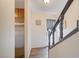 Inviting entryway with wood-look flooring, door with decorative curtain, and gray staircase at 565 Greenbriar Townhouse Way, Las Vegas, NV 89121