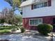 Inviting home exterior showcasing mature trees, manicured lawn and a comfortable ambiance at 565 Greenbriar Townhouse Way, Las Vegas, NV 89121