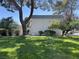 Expansive green lawn, shaded by mature trees offering a tranquil and picturesque setting at 565 Greenbriar Townhouse Way, Las Vegas, NV 89121