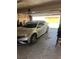 Spacious garage with a silver car parked inside, offering secure parking and storage space at 565 Greenbriar Townhouse Way, Las Vegas, NV 89121