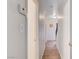 Hallway with wood floors leads to multiple rooms and a stairway at 565 Greenbriar Townhouse Way, Las Vegas, NV 89121