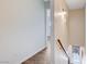 Upstairs hallway featuring hardwood floors, fresh paint, and access to rooms at 565 Greenbriar Townhouse Way, Las Vegas, NV 89121