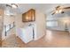 Kitchen and laundry area offers tile floors and easy access to living room and 2nd story stairs at 565 Greenbriar Townhouse Way, Las Vegas, NV 89121
