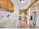 Kitchen and laundry area offers tile floors and easy access to living room at 565 Greenbriar Townhouse Way, Las Vegas, NV 89121