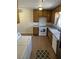 Spacious kitchen featuring wooden cabinets, a tile floor, and white appliances at 565 Greenbriar Townhouse Way, Las Vegas, NV 89121