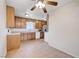 Functional kitchen area with tile flooring, cabinetry, and essential appliances at 565 Greenbriar Townhouse Way, Las Vegas, NV 89121