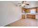 Eat-in kitchen with warm wood cabinetry, neutral countertops, and tile flooring at 565 Greenbriar Townhouse Way, Las Vegas, NV 89121