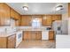 Charming kitchen featuring stainless steel appliances, tile floors, and ample cabinet space at 565 Greenbriar Townhouse Way, Las Vegas, NV 89121