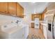 Kitchen and laundry area offers tile floors and easy access to living room at 565 Greenbriar Townhouse Way, Las Vegas, NV 89121