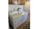 Close up of a washer and dryer set with access to plumbing at 565 Greenbriar Townhouse Way, Las Vegas, NV 89121