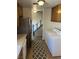 Utility area with modern appliances, tile floors and wooden cabinets at 565 Greenbriar Townhouse Way, Las Vegas, NV 89121