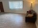 Cozy living room with fresh flooring, natural light, and comfortable seating arrangements at 565 Greenbriar Townhouse Way, Las Vegas, NV 89121